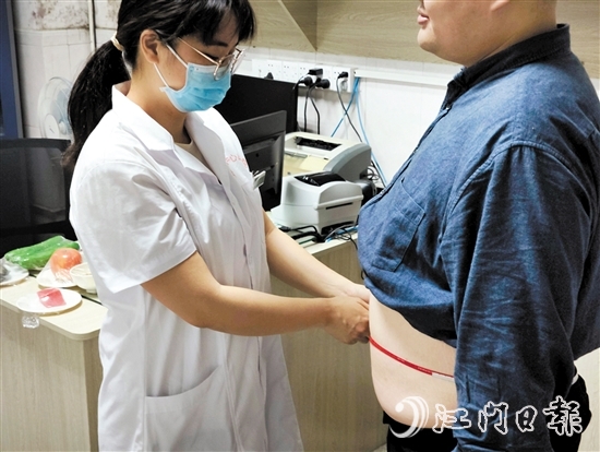 醫(yī)生為記者測(cè)量腰圍。