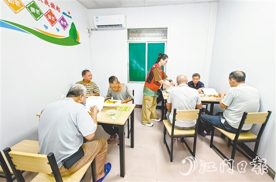 老人在助餐點(diǎn)享用熱氣騰騰的飯菜。