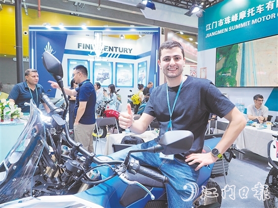 在江門市珠峰摩托車有限公司展位，外國(guó)客商前來(lái)了解摩托車新品情況，并為產(chǎn)品點(diǎn)贊。張澤彬